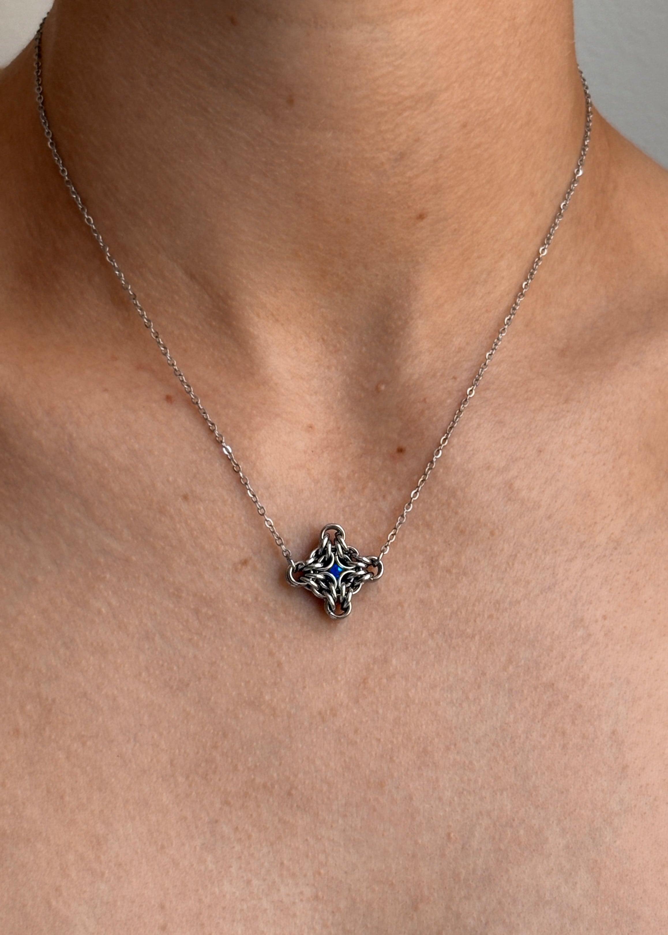 Necklace with a star-shaped pendant on a person's neck